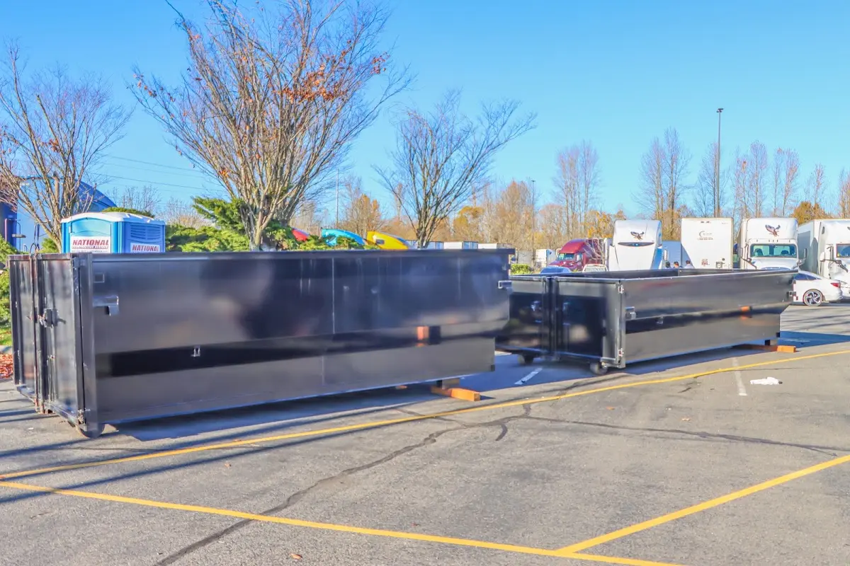 Professional dumpster rental service with roll-off container on residential driveway in Sodus